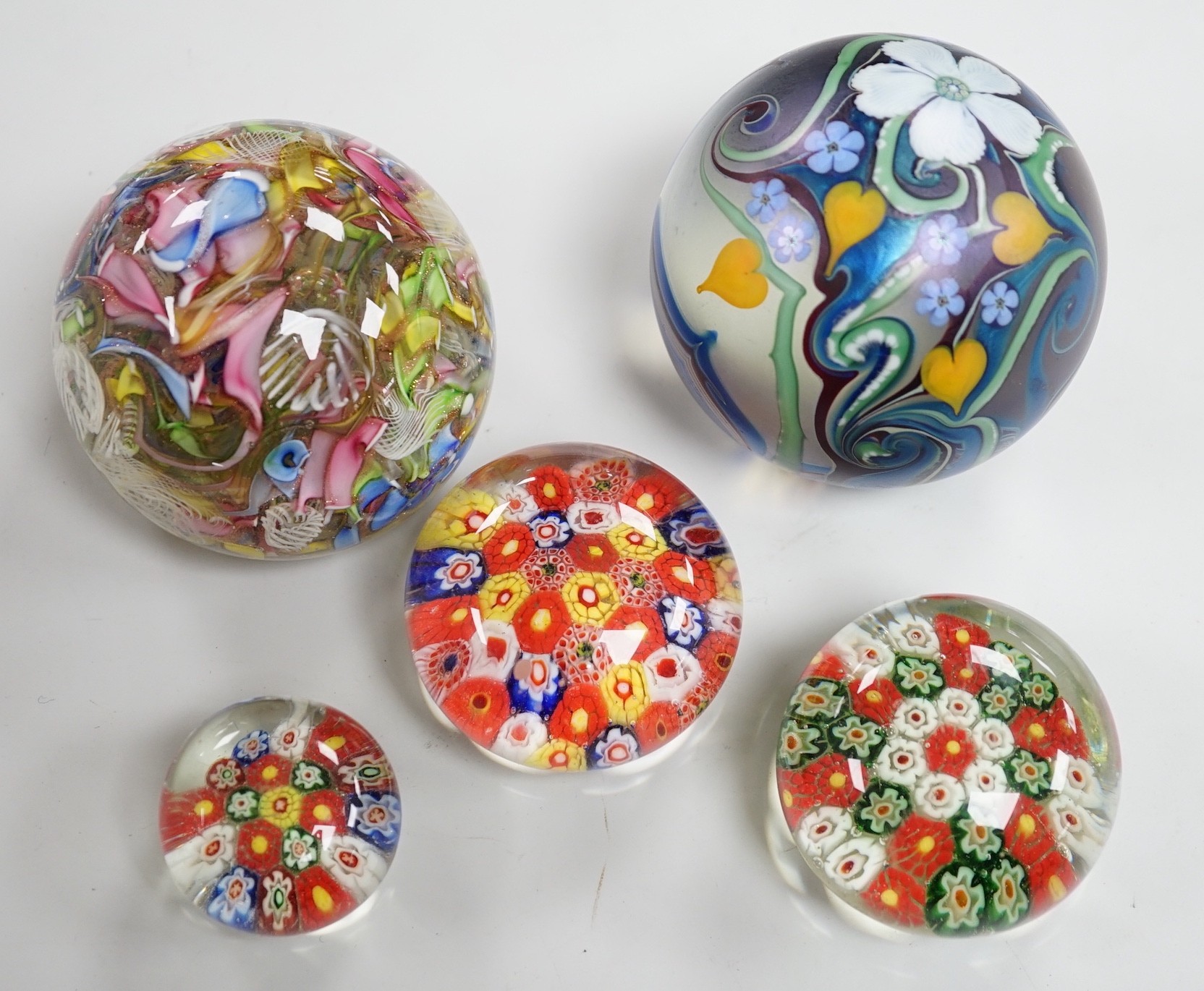 An Orient and Flume glass paperweight, a Venetian scrambled glass paperweight, and three Chinese paperweights, largest 7cm tall